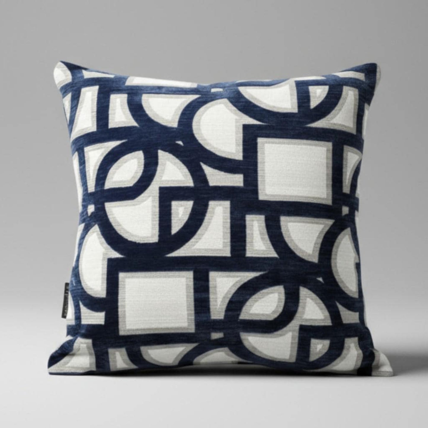 Decorative pillow with geometric pattern on a gray background