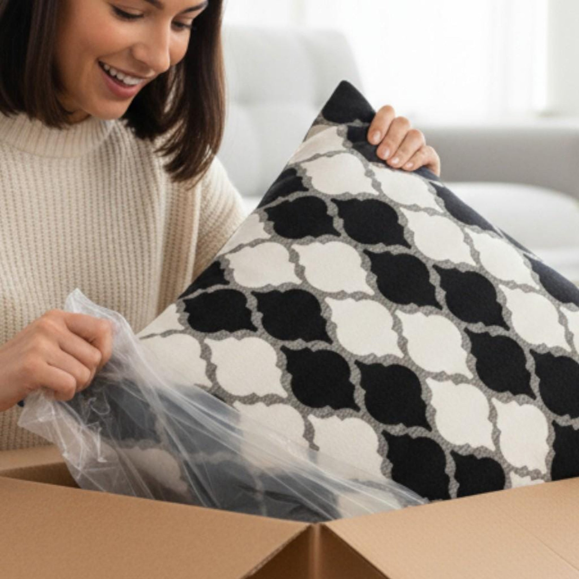 Woman unboxing a patterned pillow from a cardboard box