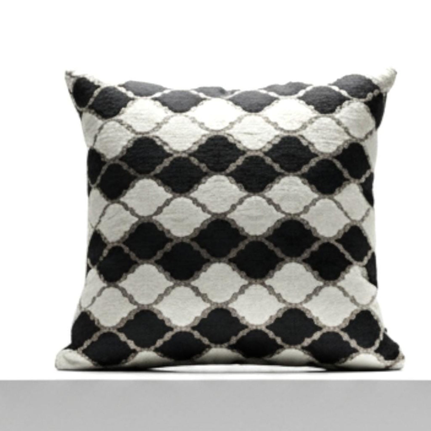 Black and white patterned pillow on a white background