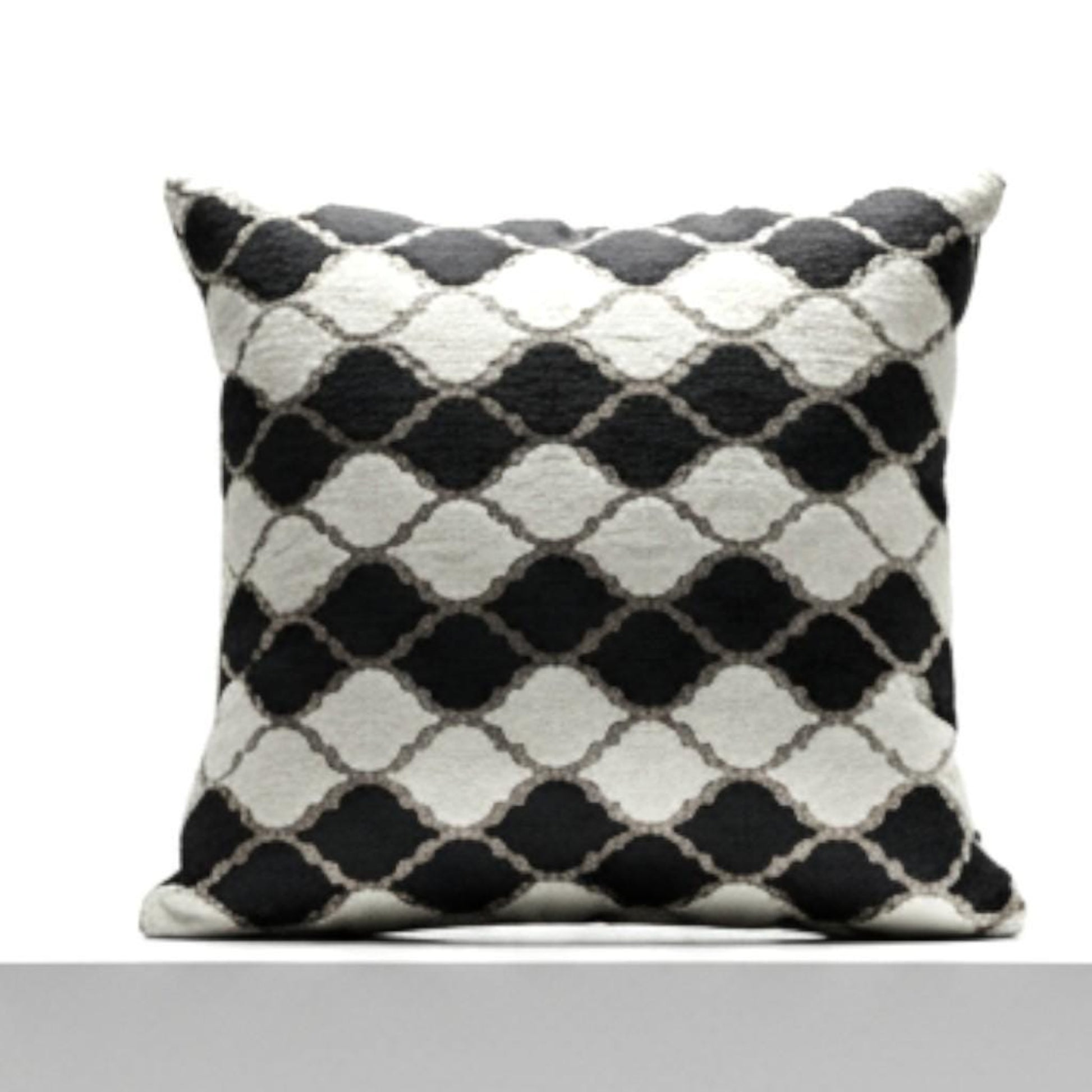 Black and white patterned pillow on a white background
